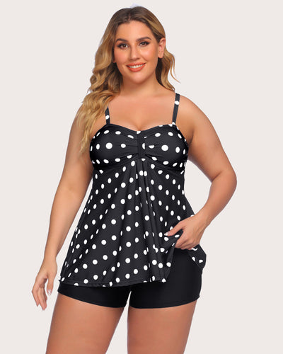 Curvy woman in white polka dot tankini and black swim shorts, stylish summer swimwear.