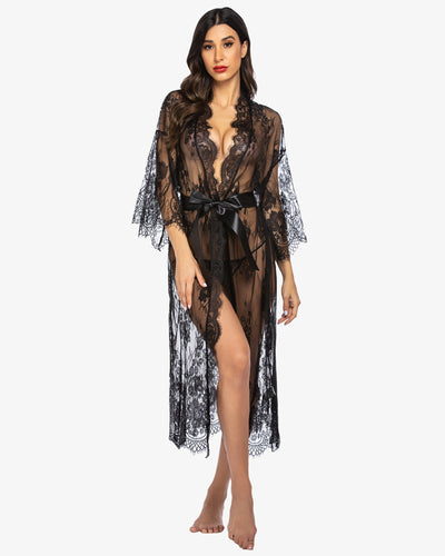 Model in sheer red lace kimono robe with satin belt, showcasing floral lace patterns.