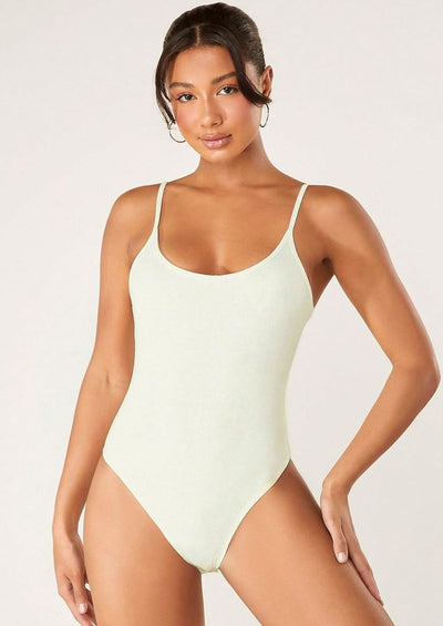 Cream ribbed tummy control romper with adjustable straps for a flattering fit.